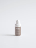 Skincare bottle labeled 'REAU' on a white background