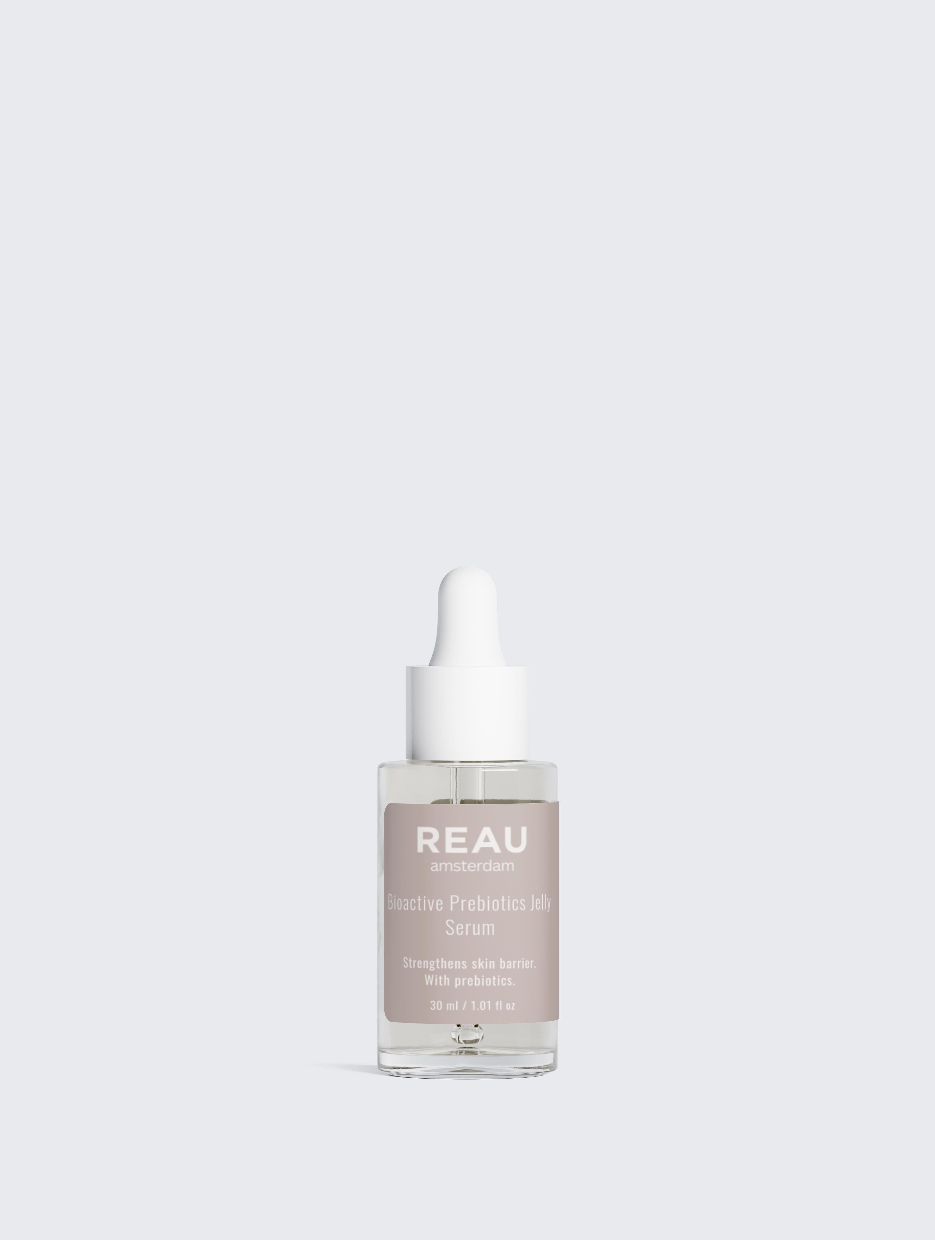 Skincare serum bottle labeled 'REAU' on a light gray background