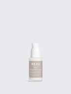 Skincare serum bottle labeled 'REAU' on a light gray background