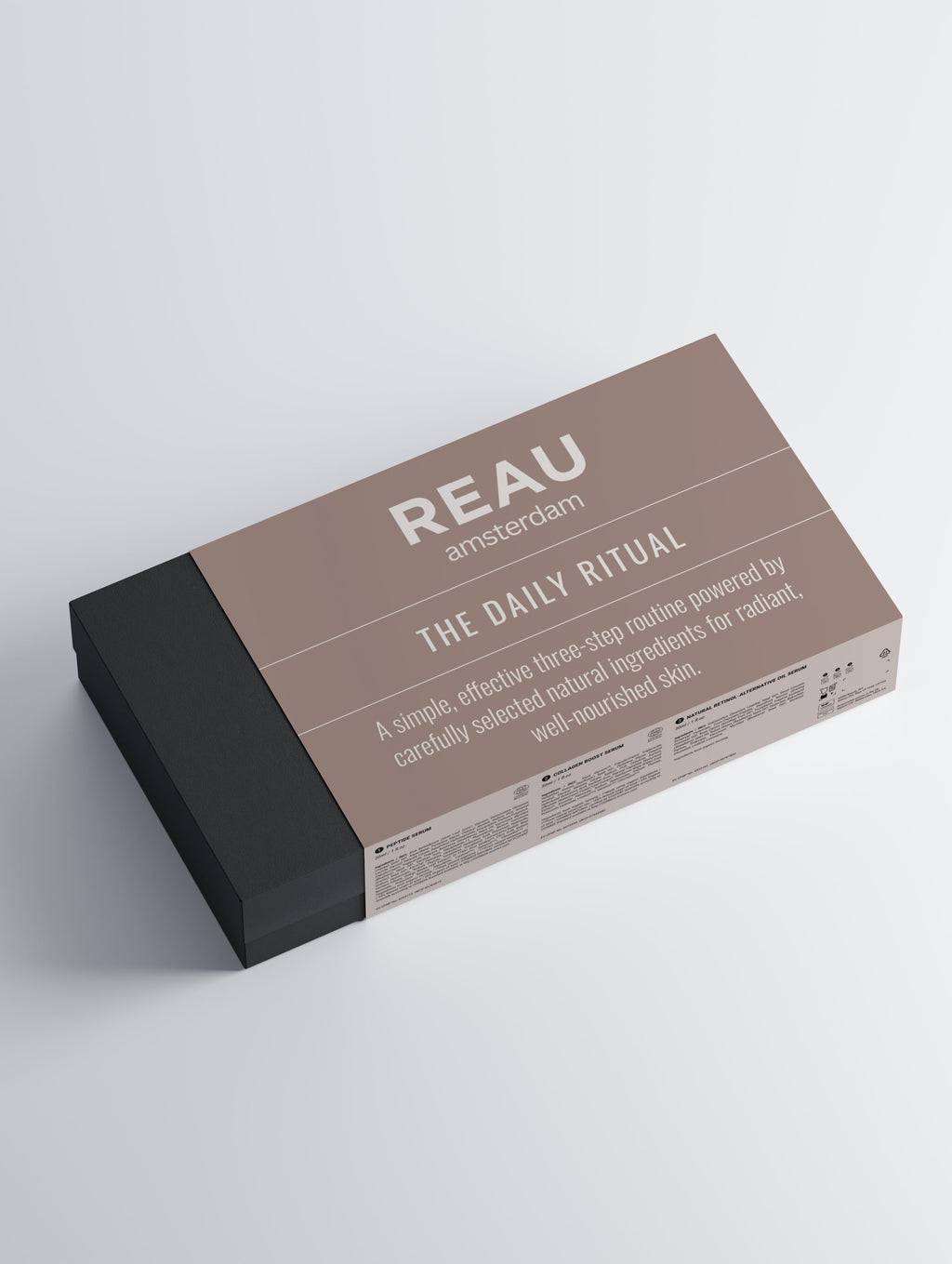 REAU Amsterdam skincare product packaging on a light gray background