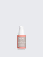 Skincare serum bottle with a white pump on a light gray background