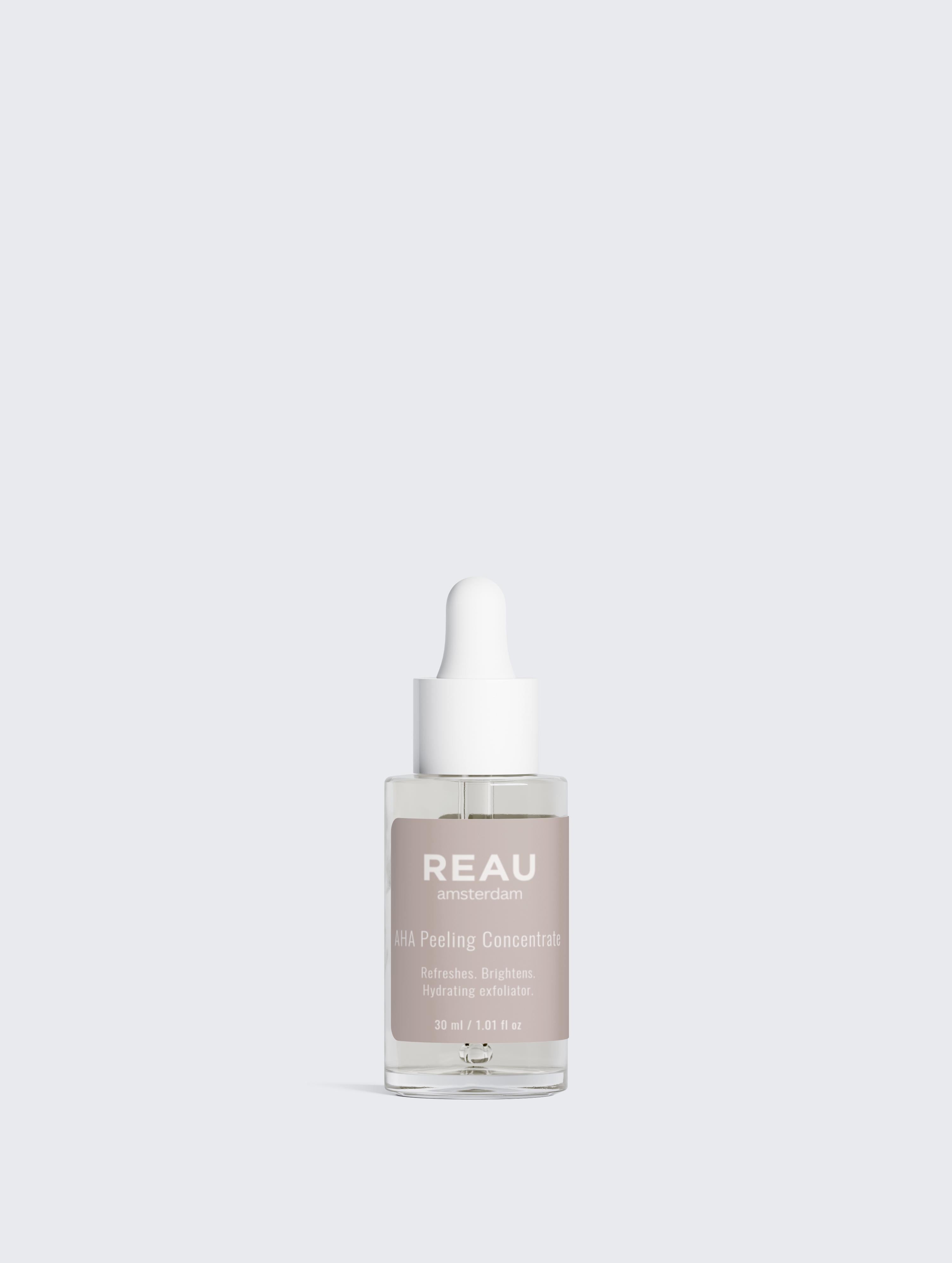 Skincare serum bottle with 'REAU' branding on a light gray background